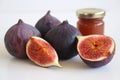 Fresh ripened purple figs. Creative composition a decorative banner of whole and sliced exotic fruit and fig jam isolated on white Royalty Free Stock Photo