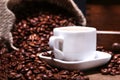 Fresh roasted coffee beans in burlap sack, espresso in cup and grinder on stone background. Royalty Free Stock Photo