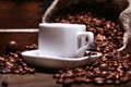 Fresh roasted coffee beans in burlap sack, espresso in cup and grinder on stone background. Royalty Free Stock Photo