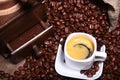 Fresh roasted coffee beans in burlap sack, espresso in cup and grinder on stone background. Royalty Free Stock Photo