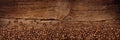 Fresh roasted coffee beans natural dark oak wood panorama wide plank wooden closeup macro background