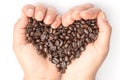 Fresh roasted coffee beans pouring in heart hands Royalty Free Stock Photo