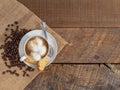Fresh roasted coffee, latte, or cappuccino in a white mug with a biscotti on a rustic wood background.