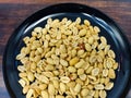 Fresh roasted peanuts served on a black plate Royalty Free Stock Photo