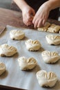 Fresh rolled buns at bakery house baking sheet pan wooden table with flour bread
