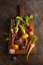 Fresh root vegetables on wooden cutting board. Autumn harvest of root vegetables. Concept healthy food