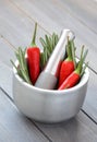 Fresh rosemary herb and red pepper in metal mortar with pestle Royalty Free Stock Photo