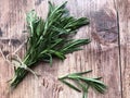 Fresh rosemary herbs on wooden background.
