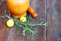 Fresh rosemary herbs in wooden pestle and mortar on wooden table Royalty Free Stock Photo