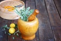 Fresh rosemary herbs in wooden pestle and mortar on wooden table Royalty Free Stock Photo