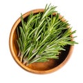 Fresh rosemary sprigs, branches of Salvia rosmarinus in wooden bowl