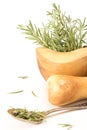 Fresh rosemary in wooden mortar with pestle on withe background. Royalty Free Stock Photo