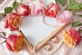 fresh roses bouquet, frame, pearl necklace, chocolate candies as heart symbol Royalty Free Stock Photo