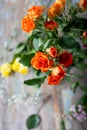 Fresh roses bouquet in orange color on wooden table. Selective focus. Floral background. Royalty Free Stock Photo