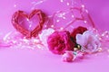 Fresh roses on a pink background, hearts, illumination, concept of romantic congratulations on Valentine`s Day, happy birthday car Royalty Free Stock Photo