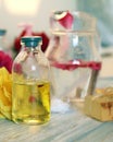 Fresh roses, soap, petals, water and oil on the table