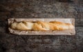 Fresh rosy baguettes on a dark wooden retro background. Top view, copy space