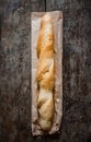 Fresh rosy baguettes on a dark wooden retro background. Top view, copy space