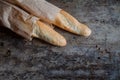 Fresh rosy baguettes on a dark wooden retro background. Top view, copy space