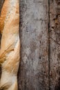 Fresh rosy baguettes on a dark wooden retro background. Top view, copy space