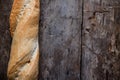 Fresh rosy baguettes on a dark wooden retro background. Top view, copy space