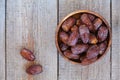 Fresh royal medjool dates in wooden bowl.