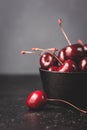 Fresh ruby cherries on black background. Dark moody close up still life Royalty Free Stock Photo