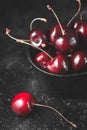 Fresh ruby cherries on black background. Dark moody close up still life Royalty Free Stock Photo
