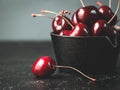 Fresh ruby cherries on black background. Dark moody close up still life Royalty Free Stock Photo