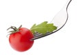 Fresh rucola salad and cherry tomato on fork isolated on white Royalty Free Stock Photo