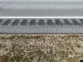 Fresh rumble strips in rural asphalt road showing white strip and stone pebble edge Royalty Free Stock Photo