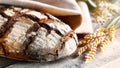 Fresh rustic bread with grain on a wooden table Royalty Free Stock Photo