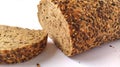 Fresh rye bread cut into pieces. White background. Bread with bran and seeds Royalty Free Stock Photo