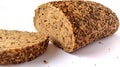 Fresh rye bread cut into pieces. White background. Bread with bran and seeds Royalty Free Stock Photo