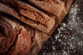 Fresh rye bread on a wooden table that is floured and covered with parchment paper. The concept of making natural homemade bread