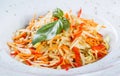 Fresh salad with apple, carrot, cabbage, celery and lemon on wooden background close up. Royalty Free Stock Photo