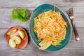 Fresh salad with apple, carrot, cabbage, celery and lemon on wooden background close up. Healthy food. Royalty Free Stock Photo