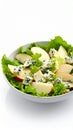 Fresh Salad with Apples and Blue Cheese in a White Bowl on White Background Royalty Free Stock Photo