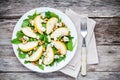 Fresh salad with arugula, pear, walnuts and blue cheese