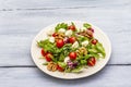 Fresh salad with arugula, radicchio, tomato cherry, baby mozzarella, walnuts