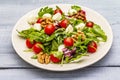 Fresh salad with arugula, radicchio, tomato cherry, baby mozzarella, walnuts