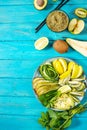 Fresh salad with avocado, kiwi, apple, cucumber, pear, lime and mint with smoothie on blue wooden background. Healthy food, Buddha Royalty Free Stock Photo