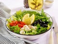 Fresh salad with avocado, tomato, olives and mozzarella in a bowl. Royalty Free Stock Photo