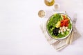 Fresh salad with avocado, tomato, olives and mozzarella in a bowl. Royalty Free Stock Photo