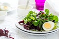 Fresh salad with beetroot, mix leaves, olive oil, egg and sesame seeds Royalty Free Stock Photo