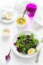 Fresh salad with beetroot, mix leaves, olive oil, egg and sesame seeds Royalty Free Stock Photo