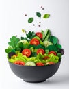 Fresh Salad in Black Bowl with Tomato and Cucumber on White Background Royalty Free Stock Photo
