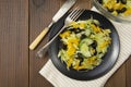 Fresh salad of black olives, iceberg cabbage, yellow bell pepper and cucumber, healthy food flat lay, natural light, wooden table