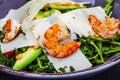 Fresh salad bowl with arugula, avocado, shrimps, parmesan cheese and pine nuts. Healthy food. Diet menu Royalty Free Stock Photo