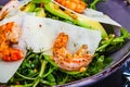 Fresh salad bowl with arugula, avocado, shrimps, parmesan cheese and pine nuts. Healthy food. Diet menu Royalty Free Stock Photo